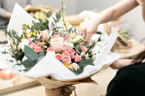 Workshop florist, making bouquets and flower arrangements. Woman collecting a Stock Photos
