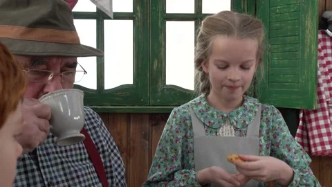 In the workshop, the Grandfather drinks tea with his grandson and granddaughter. Stock Footage 147143397