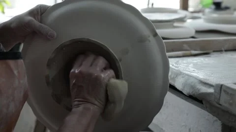 Workshop. Handmade work. A woman's hand wipes the base of the vase Video stock 130526503