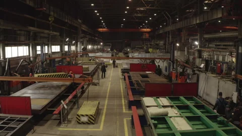 Workshop hosts workers unloading heavy container onto conveyor Stock Footage 304413997