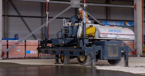 In workshop industrial leveler makes a concrete floor of a large area Stock Footage 161989234