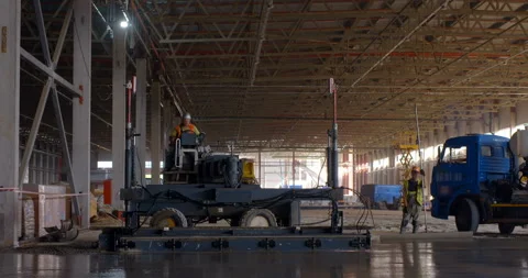 In workshop industrial leveler makes a concrete floor of a large area Stock Footage 161989778
