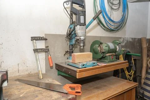 Workshop interior showing various tools like a drill press, bench grinder Stock Photos