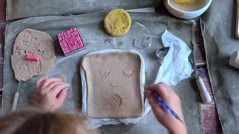 Workshop for kids. Children learning how to use clay for making dishes. Stock Footage 292742162