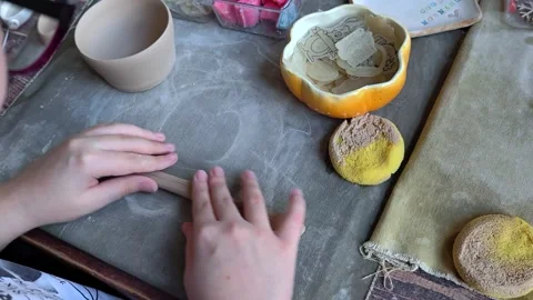 Workshop for kids. Children learning how to use clay for making dishes. Stockbeeldmateriaal 292831288