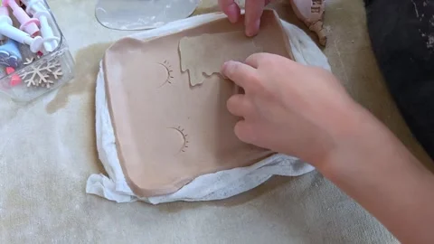 Workshop for kids. Children learning how to use clay for making dishes. Stock Footage 293044926