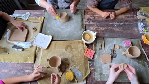 Workshop for kids. Children learning how to use clay for making dishes. Stock Footage 293140461