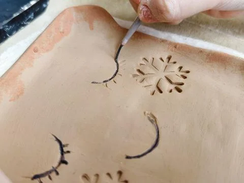 Workshop for kids. Children learning how to use clay for making dishes. Stock Photos