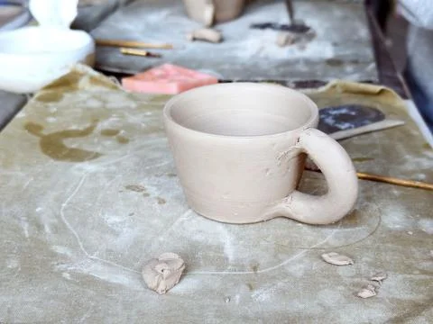 Workshop for kids. Children learning how to use clay for making dishes. Stock Photos