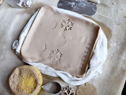 Workshop for kids. Children learning how to use clay for making dishes. Stock Photos