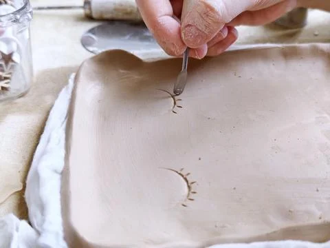 Workshop for kids. Children learning how to use clay for making beautiful dishes Stock Photos