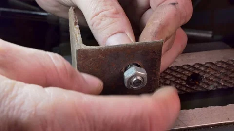 Workshop, locksmith work. The master tightens the nut using a locksmith's vise. Video stock 151438123