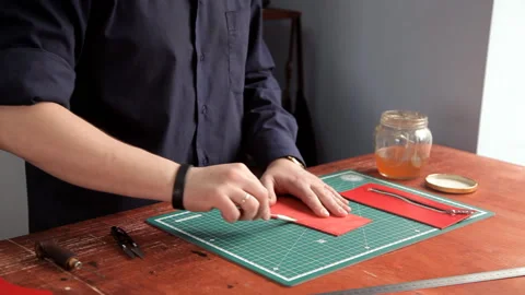 In the workshop, a man glues the workpieces of the skin, making a wallet 스톡 동영상 88832746