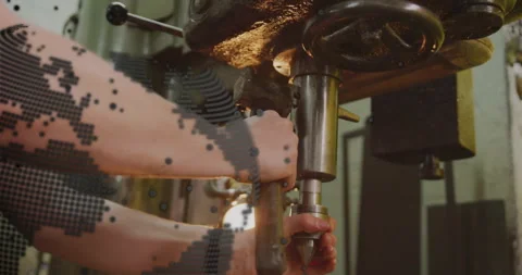 Workshop operator placing hands on lever and drilling metal making chips Stock Footage 312416852