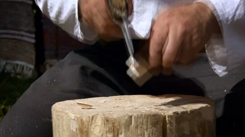 Workshop. Person Showing How to Use an Ax. Master Cutting Piece of Wood on the Stock Footage 68623068