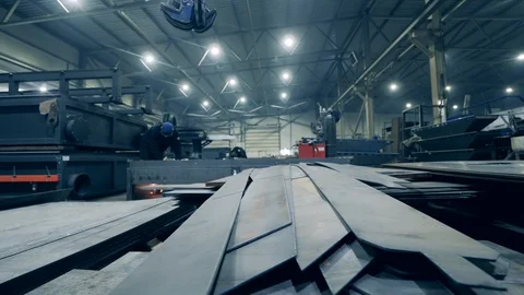 Workshop premises with metal sheets and personnel. Industrial factory facility Stock Footage 124261069