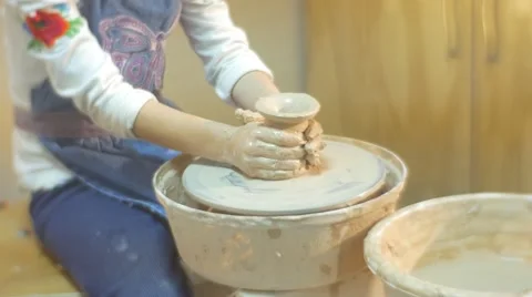 In a Workshop Producing Pottery a Small Blonde Girl in White Blouse and Blue Stock Footage 59125126