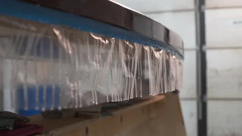 In the workshop the resin flows down from the Surf Board Video stock 132168398