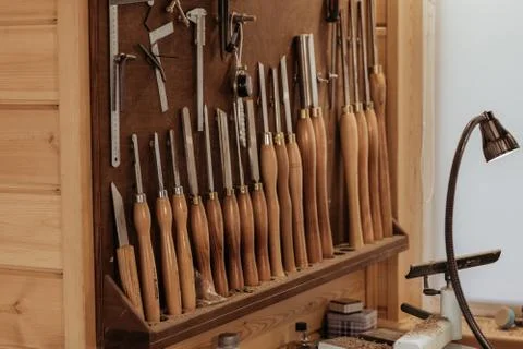 Workshop scene. Old tools hanging on wall in workshop, Tool shelf against a Stock-Fotos