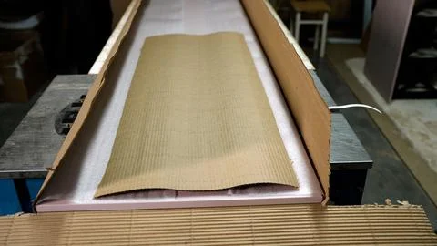 Workshop setting with new pink item being unboxed from cardboard shipping 스톡 사진