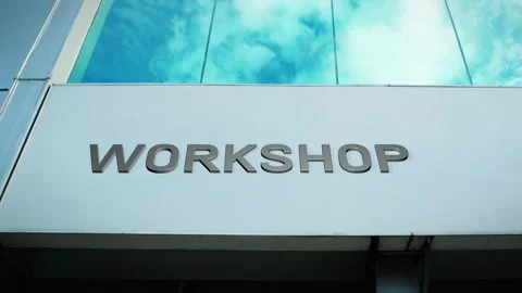 Workshop Sign on Modern Building with Cloud Reflection on Windows Glass Stock Footage 303571017