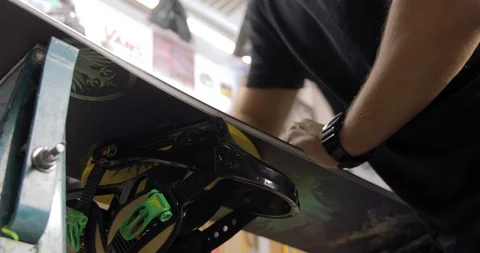 Workshop With Snowboard Repair Tools. Master Is Cleaning The Board. Low Angle Stock Footage 125857937