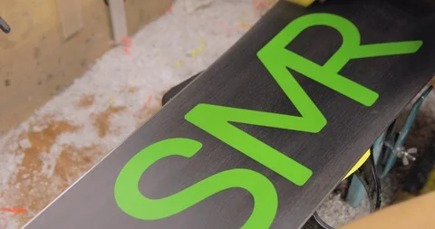 Workshop With Snowboard Repair Tools. Master Is Cleaning The Board. High Angle Stock Footage 125857942