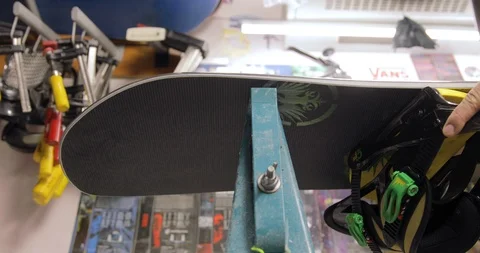 Workshop With Snowboard Repair Tools. Master Is Cleaning The Board. Low Angle Vídeo Stock 125858153