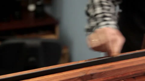 In the workshop, a specialist sharpens a leather belt. Procedure for the Stock Footage 86706873