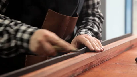 In the workshop, a specialist sharpens a leather belt. Procedure for the Stock Footage 86707369