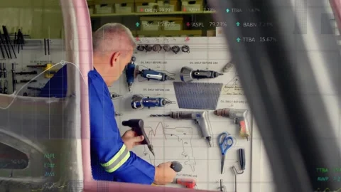 Workshop technician removing bit and snapping adapter on tool assembly with data Stock Footage 319682188