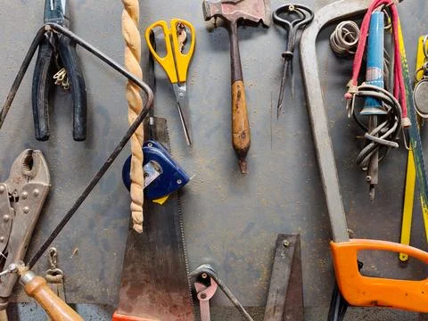 Workshop tools hanging on wall displaying craftsmanship and manual labor Stock Photos