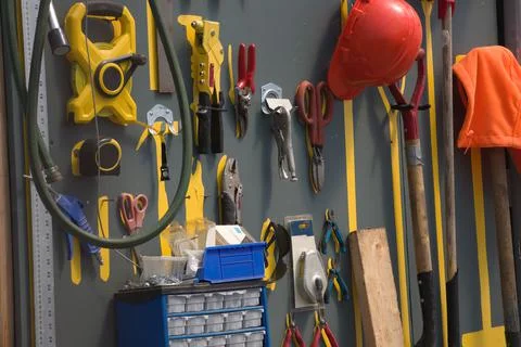 Workshop tools hanging on the wall in a shed gardening equipment Stock Photos
