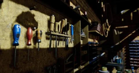 Workshop tools organized on a wooden wall in a rustic setting Ilustración de archivo