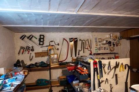 Workshop - view of a wall in a basement room with various tools in Denmark Stock Photos
