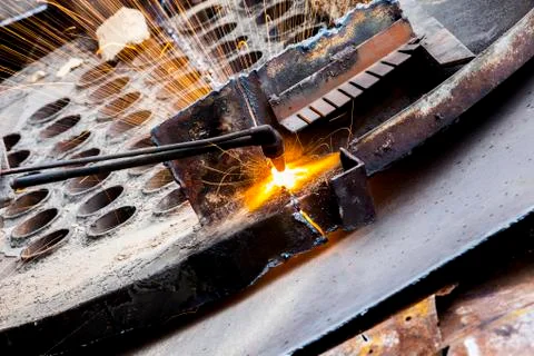 The workshop welder cuts metal Stock Photos