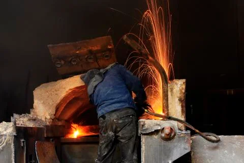 The workshop welder cuts metal Stock Photos