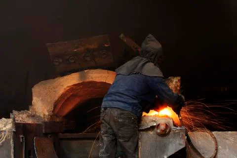 The workshop welder cuts metal Stock Photos