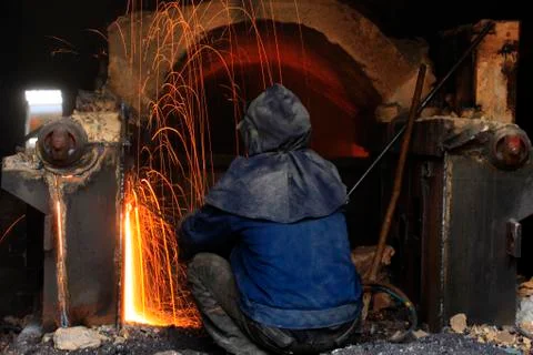 The workshop welder cuts metal Stock Photos
