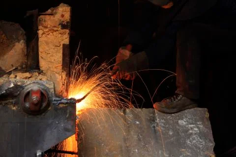 The workshop welder cuts metal Stock Photos
