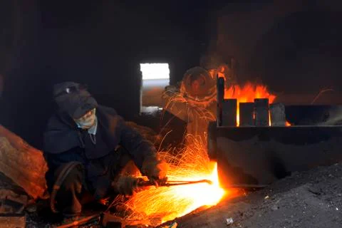 The workshop welder cuts metal Stock Photos