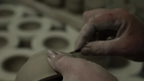 Workshop. Women's hands stroke the clay Cup, clean it from defects. Grayscal Video stock 130526242