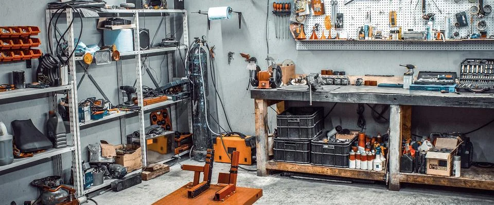 Workshop with workbench, shelving, tool kit, lift Stock Photos