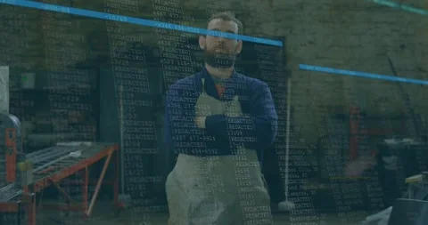 Workshop worker standing arms crossed, watching data overlay starting over him Stock Footage 331085407