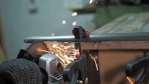 Workshop. A worker uses a angle grinder. Stock-Footage 312313945