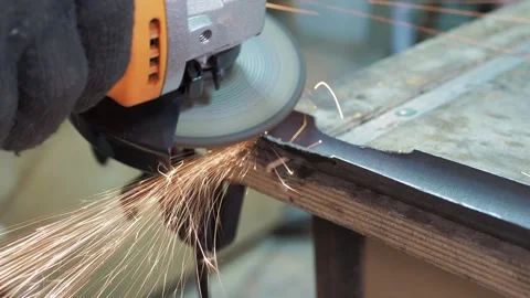 Workshop. A worker uses a angle grinder. Stock Footage 312313956