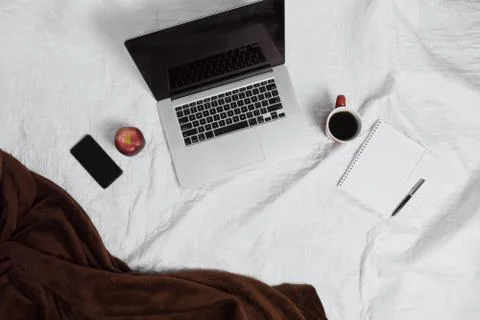 Workspace on bed. Stock Photos