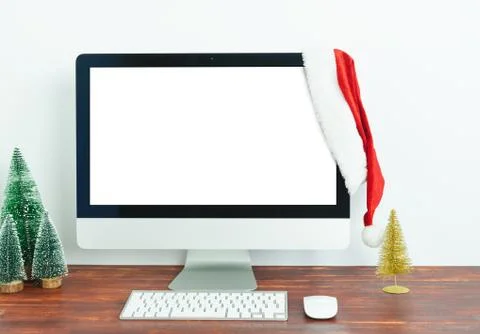 Workspace with blank computer screen and Christmas decoration Stock Photos