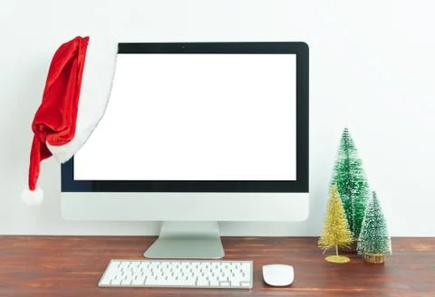 Workspace with blank computer screen and Christmas decoration Stock Photos