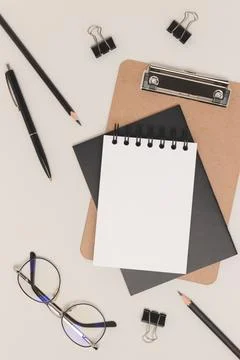 Workspace with blank notepad mock up, eyeglasses and stationery. Stock Photos